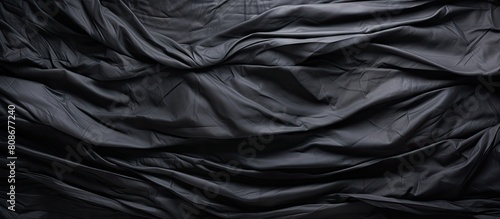 A wrinkled plastic surface on a black background serves as a high quality royalty free stock photo with realistic texture for overlay copy space and photo effects