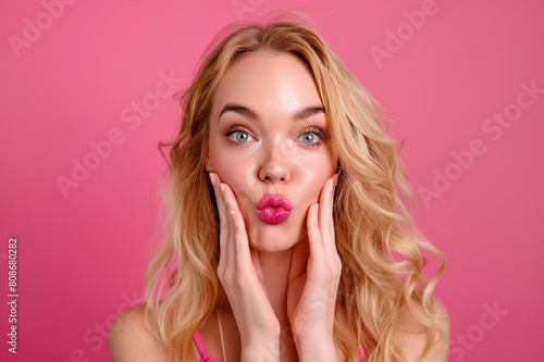 An attractive young woman blowing a kiss.