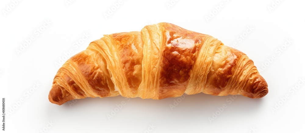 From an aerial perspective there is a croissant positioned on a blank white surface The image has been isolated and there is ample empty area for additional content From an aerial perspective there is a croissant positioned on a blank white surface The image has been isolated and there is ample empty area for additional content
