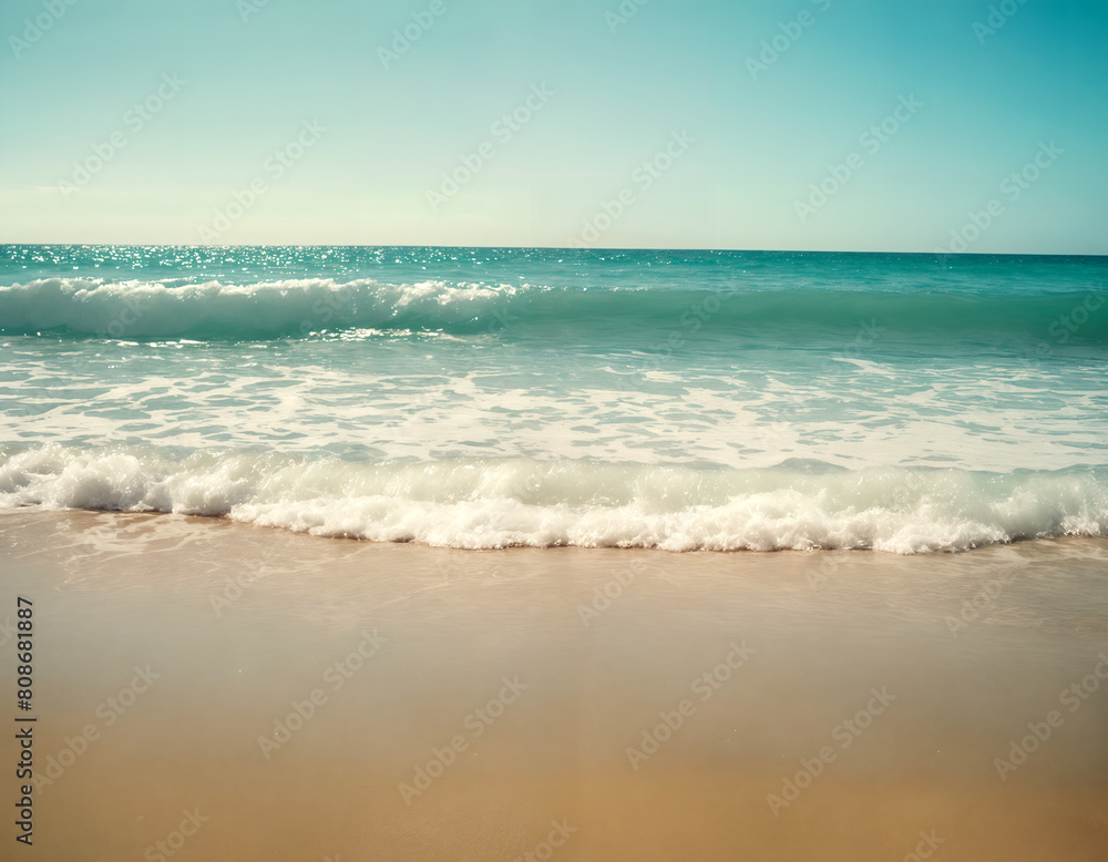 Waves on the beach. Gentle waves lapping onto a sandy shore. Clear skies. Summer vibes. Serene and tranquil mood. Natural beauty of an unspoiled beach.