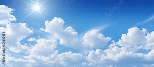 Clear day with warm sunshine creates a serene blue sky and white clouds floating in the air perfect for a wide web banner with copy space image