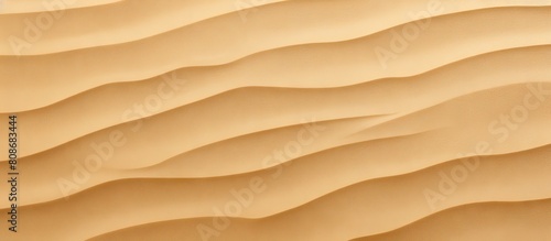Top view of a close up yellow sand texture with a natural sandy pattern and fine grains The clean flat beige sand forms a light brown desert dune surface making it an ideal copy space image for a sum © Ilgun