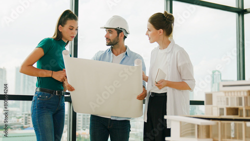 Professional architect engineer team talking, sharing, brainstorming about design while manager hold at project plan. Young architect holding plan while manager listen and point at plan. Tracery © Summit Art Creations