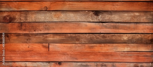 Copy space image of a rustic wooden background made from weathered boards showcasing a warm brick red orange color palette