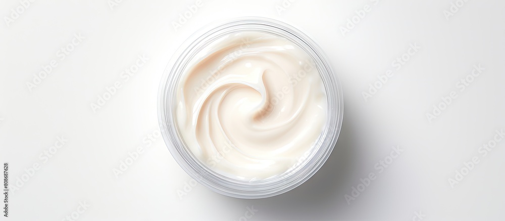 A healing hand cream sits in an open jar with visible texture on a white background offering moisturizing care for troubled skin The top view promotes the concept of healthy skin and beauty Copy spac A healing hand cream sits in an open jar with visible texture on a white background offering moisturizing care for troubled skin The top view promotes the concept of healthy skin and beauty Copy spac