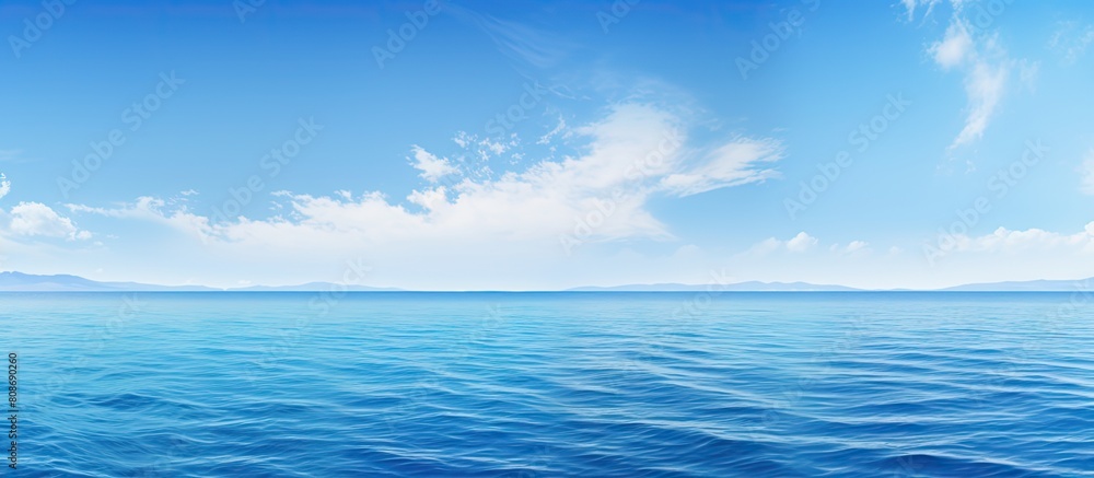 The gorgeous scenery features a captivating combination of a clear blue sky and an endless expanse of blue sea Copy space image The gorgeous scenery features a captivating combination of a clear blue sky and an endless expanse of blue sea Copy space image