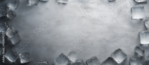 Grey table with ice cubes arranged in a flat lay composition creating ample empty space for adding text or other copy in the image photo