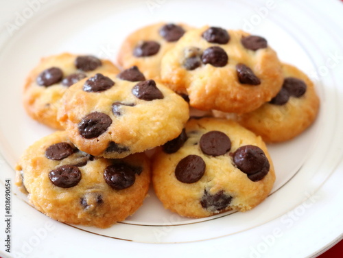 Chocolate chip cookies pile on white background.