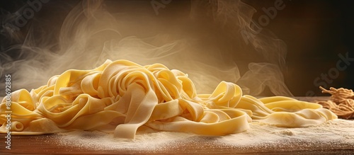 A handmade raw durum wheat tagliatelle egg pasta is being cooked and it is now ready on the table as a copy space image for food background