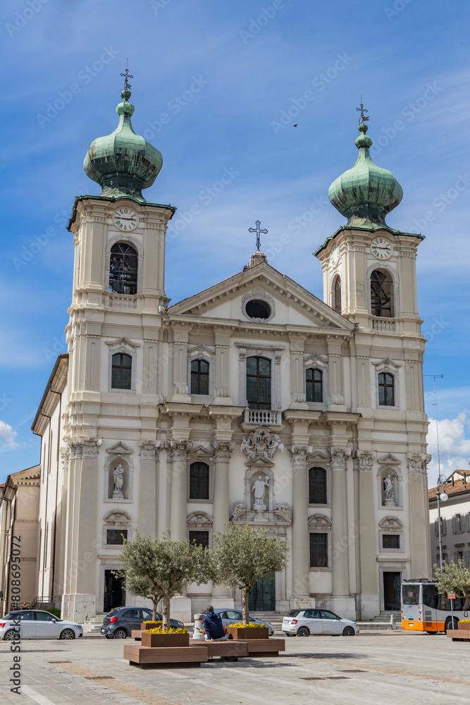 Obraz premium City of Gorizia, Piazza della Vittoria with the Church of Sant'Ignazio and the fountain. The beautiful streets and the castle behind them are a trace of history. Cultural Heritage Capital 2025.