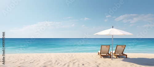 A serene beach scene showing two sunbeds facing the ocean with a generous amount of empty space for a copy. Copy space image. Place for adding text and design © Ilgun