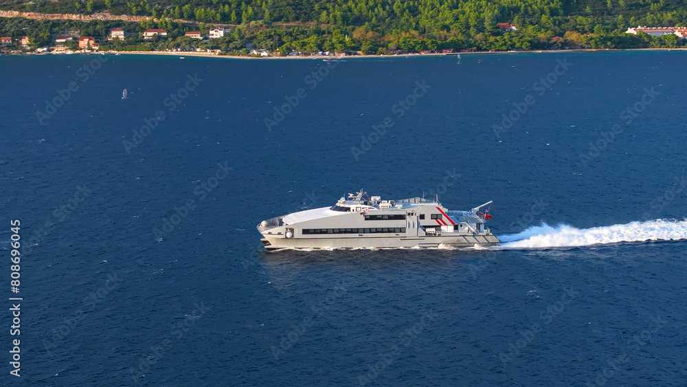 AERIAL: Drone view of a public transport catamaran sailing in the Mediterranean.