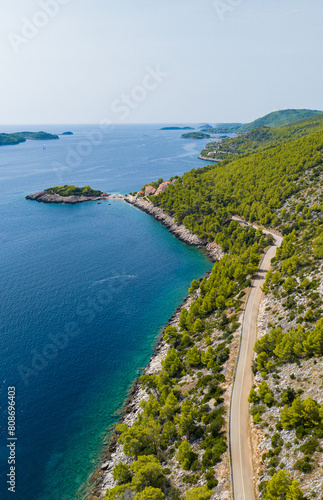 VERTICAL: Flying along the green Mediterranean island in Dalmatia, Croatia.