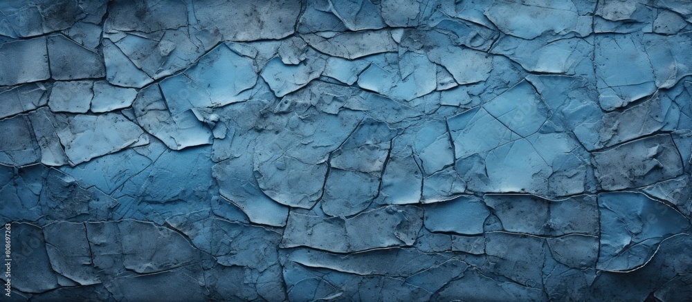 An abstract background for design featuring an aged blue textured wall with crack lines and patches of black dirt Perfect for copy space image