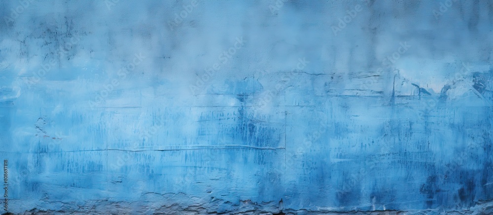 Fototapeta premium A textured blue painted wall provides a background with copy space image