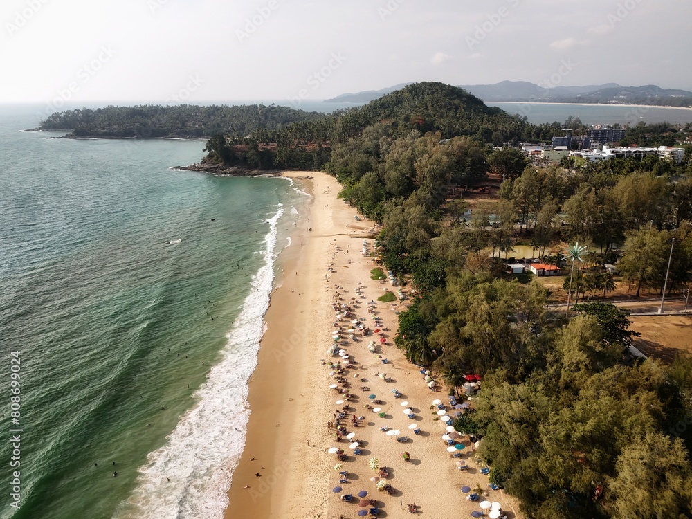Aerial view sea beach on holiday. People playing in the water, walking on the beach On vacation. Footage of tourist attractions in Thailand with foreigners Come in for a vacation weekend, wave water
