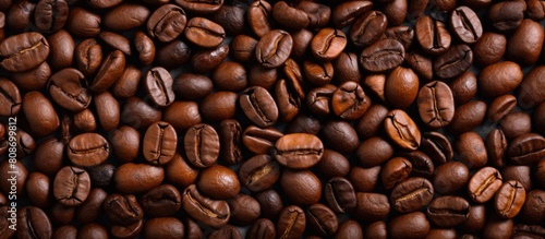 Top view of a background with a textured image of roasted coffee beans creating a copy space image