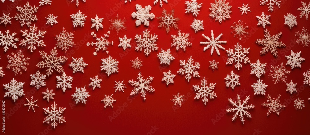 A top down view of Christmas snowflakes on a red knitted background with ample space for additional imagery A top down view of Christmas snowflakes on a red knitted background with ample space for additional imagery