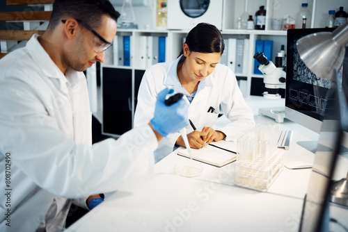 Science  team and pipette on petri dish for research  test or chemical analysis for health innovation in lab. Dropper  scientist and people in medical study of drugs  biotechnology or writing notes