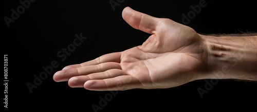 A hand with copy space is held by a person as seen from the left side
