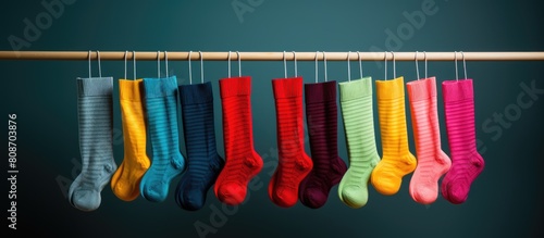 Colorful socks hang on a radiator creating a vibrant and lively display. Copy space image. Place for adding text and design