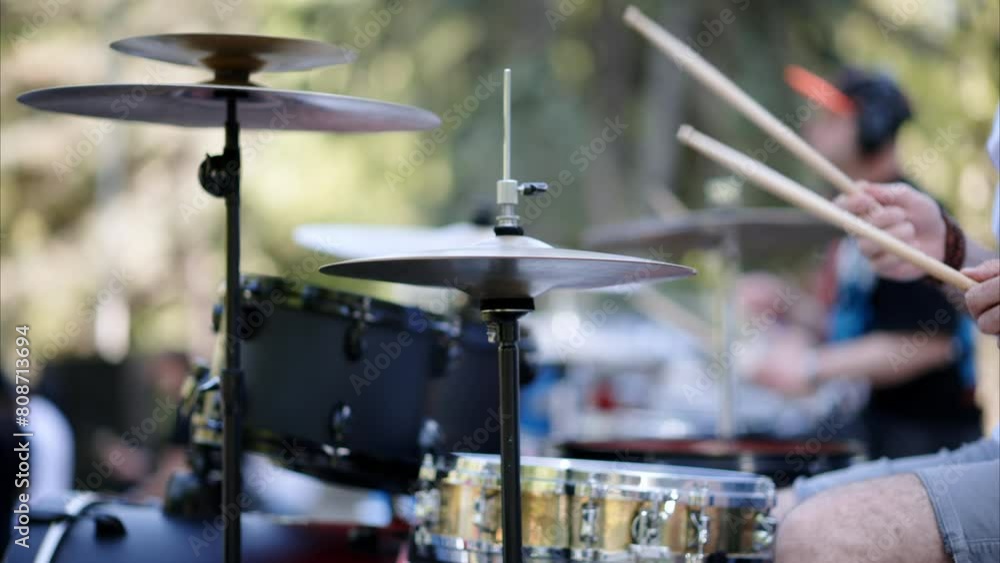 Close up of man playing red drums outside. Close up of man playing red drums outside.