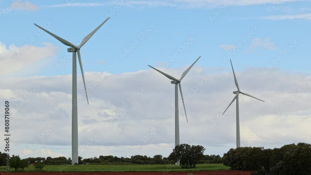 Wind farm in an agricultural field against cloudy sky Wind farm in an agricultural field against cloudy sky