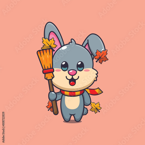 Cute autumn rabbit holding broom cartoon vector illustration
