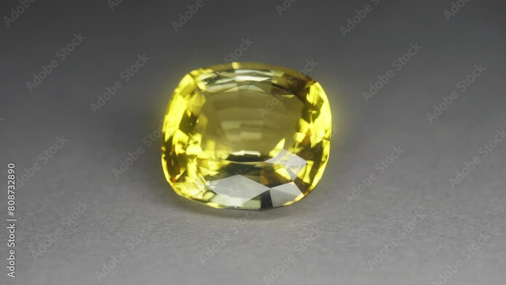 Polished yellow gemstone rotates and sparkles Polished yellow gemstone rotates and sparkles