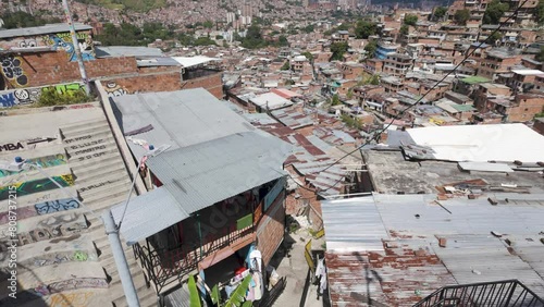 Pan up from top of stairs across dense populated valley of Communa 13 in Medellin Colombia photo