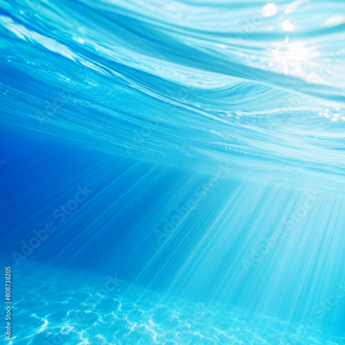 Underwater view of blue sea water with sun rays. Underwater background