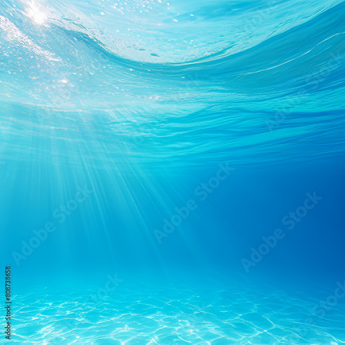 Underwater view of blue sea water with sun rays. Underwater background
