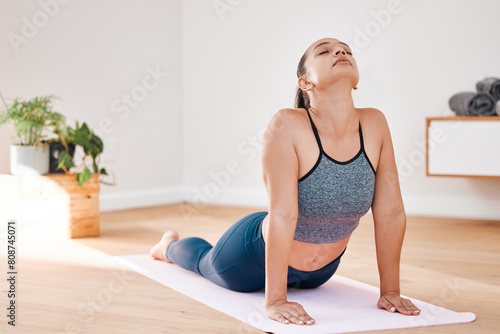 Cobra pose yoga or woman in home for stretching, wellness or body flexibility in zen studio for peace. Aura, chakra energy or calm girl on mat for mindfulness, meditation or spine in pilates session