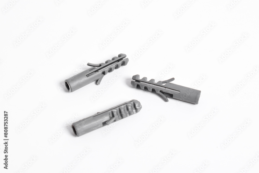 Grey plastic dowels for screws on a white isolated background Grey plastic dowels for screws on a white isolated background