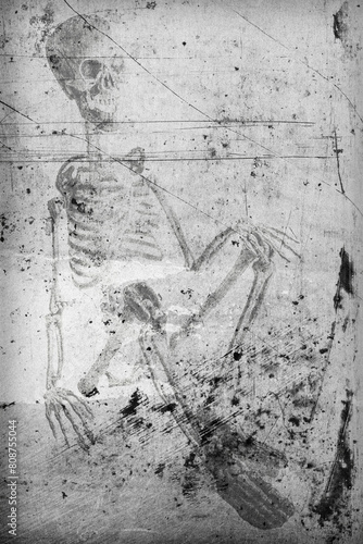 empreinte d'un squelette homme en position assise, incrusté dans un vieux mur photo