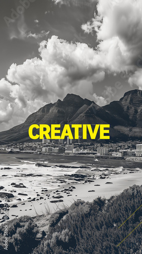 This captivating black and white photograph showcases the stunning mountains against a backdrop of a serene beach. Overlaying the image is bold yellow text that reads "CREATIVE" adding a vibrancy