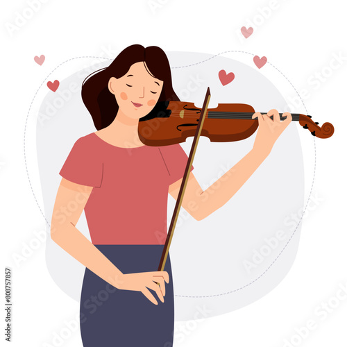 The girl plays the violin. A woman musician stands with a violin. Valentine's Day.