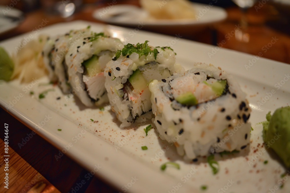 Plate of California Roll Sushi With Cucumber Topping Plate of California Roll Sushi With Cucumber Topping