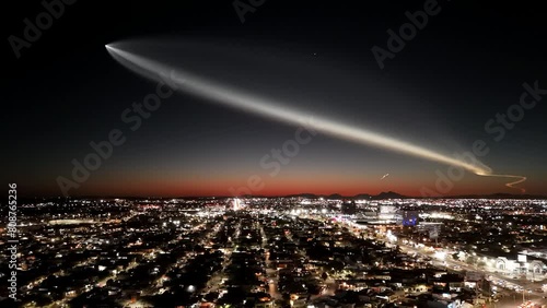 Aerial footage of a rocket crossing the dark dusk sky over Hermosillo city, Sonora, Mexico photo