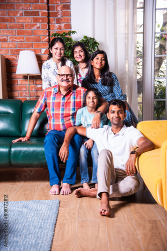 Photography Happy Indian asian family consists of grandparents, parents and kids posing for