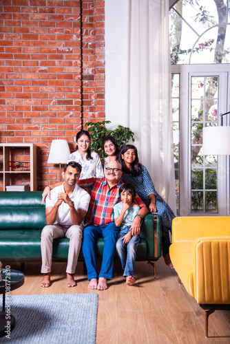 Photography Happy Indian asian family consists of grandparents, parents and kids posing for