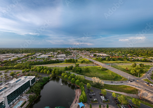 A distant aerial view of downtown Lexington  KY  from the intersection of New Circle Road and Nicholasville Road  showcases the pond of the Lexington Green shopping and entertainment complex