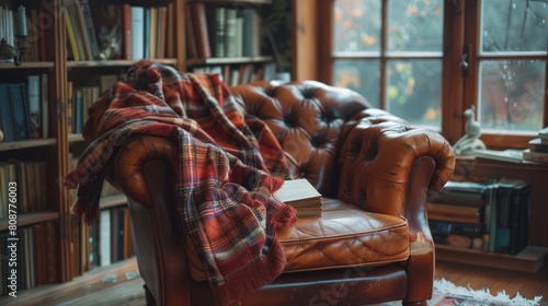 cozy reading nook, a plaid blanket on a leather armchair creates a cozy reading nook, ideal for curling up with a book on a lazy afternoon