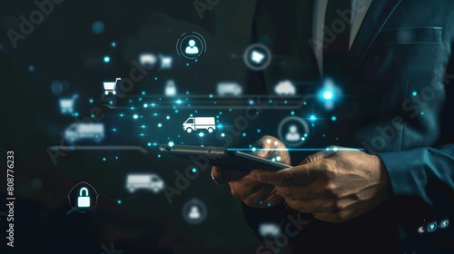 Online transportation service: blurry dark background with a Man in a suit with a tablet