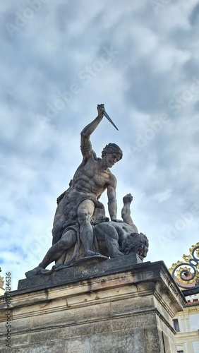 Angry Stone Statue Man Stabbing another man with Knife, Gray Dramatic Clouds