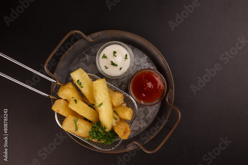 Fried Yucca or Cassava Sticks with Sauce.  photo