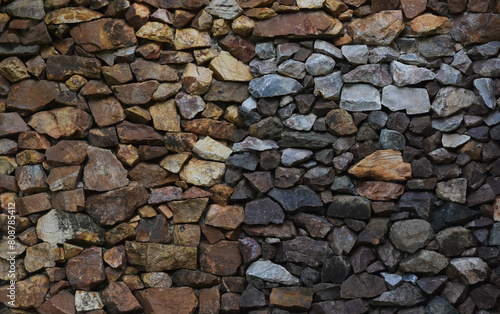 Multi-colored stones make a house wall as a background.