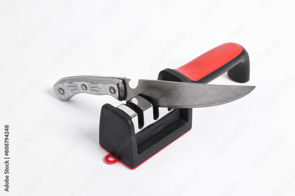 Knife and knife Sharpener isolated on white background. Manual knife sharpening, Kitchen tools Knife and knife Sharpener isolated on white background. Manual knife sharpening, Kitchen tools