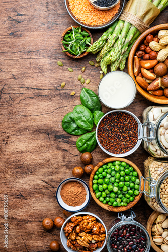 Vegan food background with empty space. Plant protein.  vegetarian nutrition sources. Healthy eating  diet ingredients  legumes  beans  lentils  nuts  soy milk  tofu  cereals  seeds and sprouts