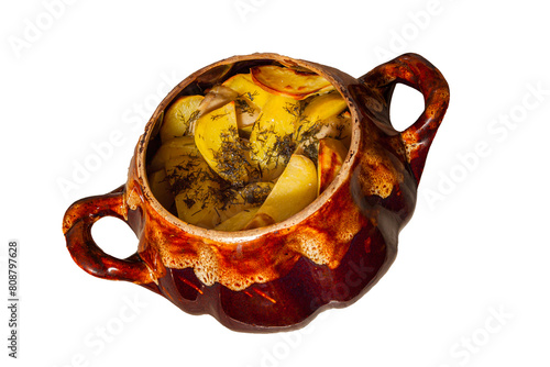 Potatoes baked in a cauldron.On a white isolated background. The chef prepares fried potatoes in a wood-burning oven in nature. Decorated with greenery. Close-up. food on a round plate.